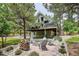 Exterior of home showcases a fire pit with chairs and mature landscaping at 7312 Marshall Rd, Larkspur, CO 80118