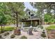 Exterior of home showcases a fire pit with chairs and mature landscaping at 7312 Marshall Rd, Larkspur, CO 80118