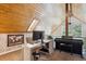 Home office with a bright wood ceiling, a work station, and grand piano near a window at 7312 Marshall Rd, Larkspur, CO 80118