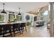 Open-concept kitchen with large island, barstool seating, and adjacent dining room at 7312 Marshall Rd, Larkspur, CO 80118