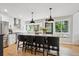 Bright kitchen with island seating, stainless steel appliances, and views of the outdoors at 7312 Marshall Rd, Larkspur, CO 80118