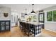 Well-designed kitchen with large island, bar stool seating, stainless appliances, and modern fixtures at 7312 Marshall Rd, Larkspur, CO 80118