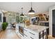 Modern kitchen with an island, view to the dining and living space with stairs in view at 7312 Marshall Rd, Larkspur, CO 80118