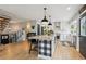 Spacious kitchen with island seating, white cabinetry, and modern design elements at 7312 Marshall Rd, Larkspur, CO 80118
