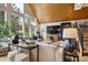 Stylish living room with vaulted ceilings, large windows, wood accents, and comfortable seating with accent pillows at 7312 Marshall Rd, Larkspur, CO 80118