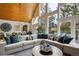 Spacious living room features vaulted ceilings, oversized windows, and comfortable seating with accents of blue and white at 7312 Marshall Rd, Larkspur, CO 80118