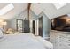 Bright main bedroom features vaulted ceilings, skylights, and a sliding barn door closet at 7312 Marshall Rd, Larkspur, CO 80118