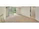 An open basement featuring neutral carpet, white walls and a sliding glass door to the backyard at 3775 S Poplar St, Denver, CO 80237