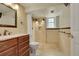 Well-lit bathroom with a spacious shower, tile flooring and cherry wood vanity at 3775 S Poplar St, Denver, CO 80237