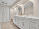 Bathroom with dual vanity, white cabinets, and stainless steel finishes at 3775 S Poplar St, Denver, CO 80237