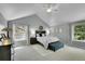 Bright primary bedroom features large windows, vaulted ceiling, and neutral decor at 3775 S Poplar St, Denver, CO 80237