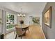 Bright dining room with hardwood floors, stylish chandelier, and large windows at 3775 S Poplar St, Denver, CO 80237