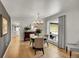 Bright dining room with hardwood floors, stylish chandelier, and large windows at 3775 S Poplar St, Denver, CO 80237