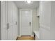 Entryway with white door, white cabinets, and a bench seat at 3775 S Poplar St, Denver, CO 80237