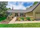 Charming brick home with well-manicured lawn, beautiful landscaping, and cozy outdoor seating area at 3775 S Poplar St, Denver, CO 80237