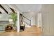 Inviting foyer with hardwood floors, staircase, and a view into the spacious living area at 3775 S Poplar St, Denver, CO 80237