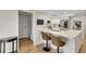 Modern kitchen with a breakfast bar, stainless appliances, and hardwood floors throughout at 3775 S Poplar St, Denver, CO 80237