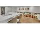 Modern kitchen with white countertops and stainless steel appliances; living room in view at 3775 S Poplar St, Denver, CO 80237