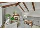 Cozy living room with vaulted ceilings, exposed beams, a fireplace, and comfortable seating at 3775 S Poplar St, Denver, CO 80237