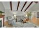 Cozy living room with vaulted ceilings, exposed beams, a fireplace, and comfortable seating at 3775 S Poplar St, Denver, CO 80237