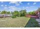 Grassy backyard with a wood fence and raised deck, creating a private outdoor space at 3871 W Saratoga Ave, Littleton, CO 80123