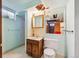 Basement bathroom featuring an older vanity and a stall shower at 3871 W Saratoga Ave, Littleton, CO 80123