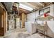 Unfinished basement with utility connections, includes a washing machine, sink, and water heater at 3871 W Saratoga Ave, Littleton, CO 80123