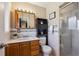 Bathroom with a wooden vanity and a framed glass shower at 3871 W Saratoga Ave, Littleton, CO 80123