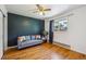 Cozy bedroom with hardwood floors and a comfortable seating area at 3871 W Saratoga Ave, Littleton, CO 80123