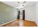 Neutral bedroom featuring hardwood floors and a view to the exterior at 3871 W Saratoga Ave, Littleton, CO 80123