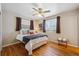 Bright bedroom featuring hardwood floors, a ceiling fan, and natural light at 3871 W Saratoga Ave, Littleton, CO 80123