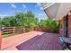 Wooden deck with painted red railings and flooring offers an outdoor lounging space at 3871 W Saratoga Ave, Littleton, CO 80123