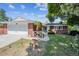 Attractive brick home featuring an attached garage, landscaped front yard and inviting entrance at 3871 W Saratoga Ave, Littleton, CO 80123
