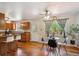 Eat-in kitchen features hardwood floors, ceiling fan and breakfast bar that seats three people at 3871 W Saratoga Ave, Littleton, CO 80123