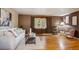 Cozy living room features hardwood floors, a large window, and comfortable seating arrangement at 3871 W Saratoga Ave, Littleton, CO 80123