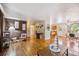 Open living space with hardwood floors, stylish furnishings, and seamless flow to kitchen at 3871 W Saratoga Ave, Littleton, CO 80123