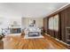 Bright living room boasts a fireplace, hardwood floors, and comfortable seating area at 3871 W Saratoga Ave, Littleton, CO 80123