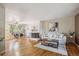 Spacious open floor plan with hardwood floors, fireplace, and dining area with large windows at 3871 W Saratoga Ave, Littleton, CO 80123