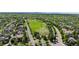 Beautiful aerial view showcasing neighborhood with nearby green space and city skyline in distance at 652 Ulster Way, Denver, CO 80230