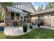 Backyard patio area featuring a dining table, chairs, a grill, and lush greenery, perfect for relaxation and entertaining at 652 Ulster Way, Denver, CO 80230