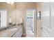 Bathroom with granite countertop, white cabinets, and a shower room with white tiles at 652 Ulster Way, Denver, CO 80230