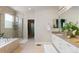 A modern bathroom featuring tiled floors, a glass shower, and dual vanity with granite countertop at 652 Ulster Way, Denver, CO 80230
