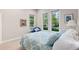 Inviting bedroom with a comfortable bed and a view of the green outdoors through the windows at 652 Ulster Way, Denver, CO 80230