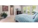 Bedroom featuring a large bed and a view of the green outdoors through the windows at 652 Ulster Way, Denver, CO 80230