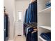 Walk-in closet with built-in storage shelves and rods for hanging clothes at 652 Ulster Way, Denver, CO 80230