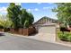 Attached two-car garage with well-maintained driveway and landscaping, offering convenience at 652 Ulster Way, Denver, CO 80230
