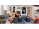 Inviting living area with a fireplace, built-in bookshelves, hardwood floors, and comfortable seating arrangement at 652 Ulster Way, Denver, CO 80230