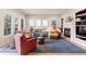 Bright and airy living room with large windows, a cozy fireplace, stylish furnishings, and neutral color palette at 652 Ulster Way, Denver, CO 80230