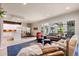 A spacious living area featuring an open floor plan, hardwood floors, a modern kitchen, and comfortable seating arrangement at 652 Ulster Way, Denver, CO 80230