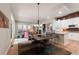 Open-concept living space with a dining area, kitchen, and cozy fireplace at 652 Ulster Way, Denver, CO 80230